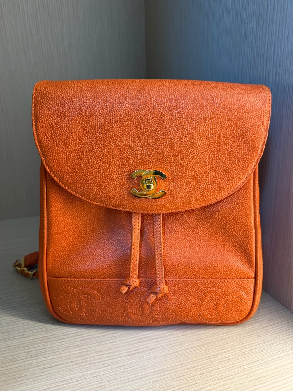 CHANEL Orange Caviar Leather Backpack with Gold CC Turnlock.